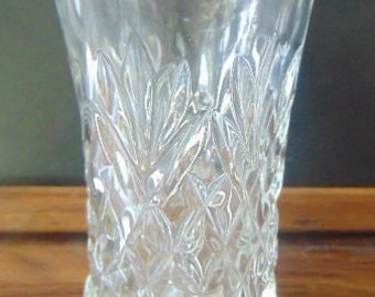 May include: A clear glass drinking glass with a diamond pattern.