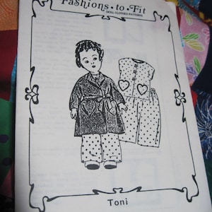 May include: A black and white illustration of a doll wearing a polka dot dress and a coat with a heart design. The image is from a doll clothes pattern called "Fashions to Fit" and is titled "Toni".