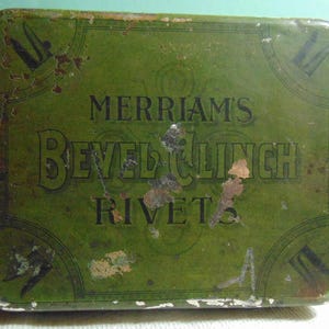 May include: A green metal box with the words "Merriam's Bevel Clinch Rivets" printed on it. The box is slightly worn and has some rust spots.