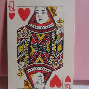 May include: Queen of Hearts playing card with a red heart suit and a red queen symbol. The queen is depicted wearing a red and white crown and a red and white dress. The card has a white background with a black and red border.