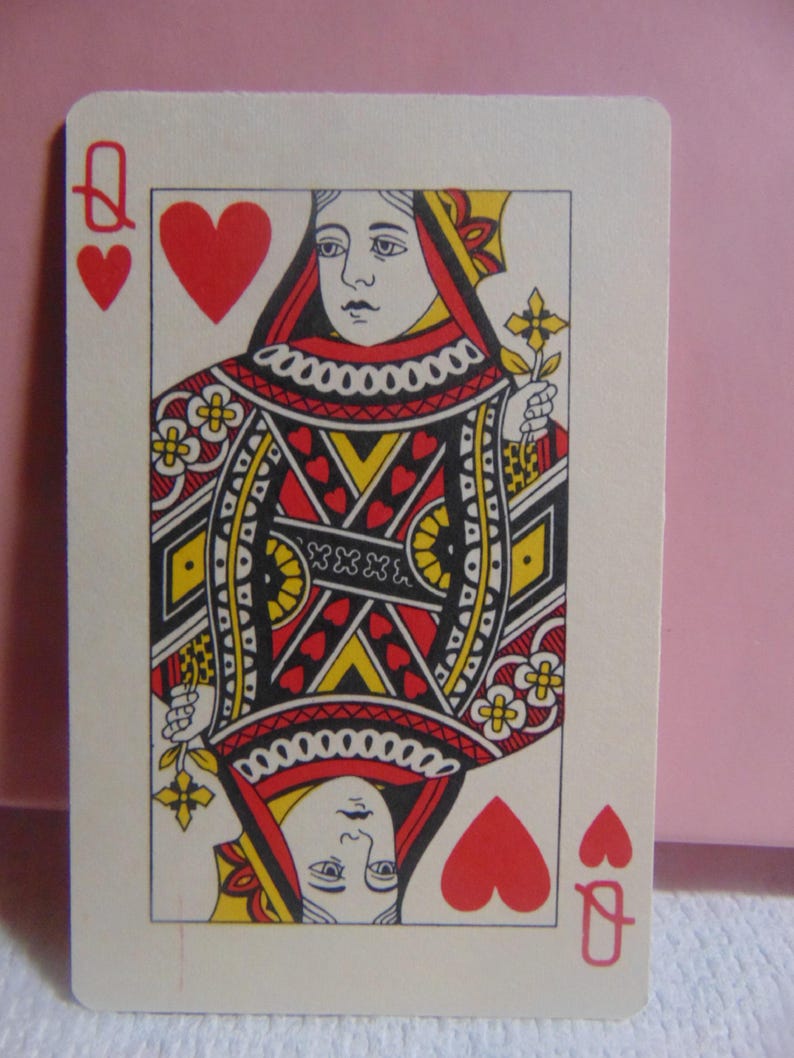 May include: Queen of Hearts playing card with a red heart suit and a red queen symbol. The queen is depicted wearing a red and white crown and a red and white dress. The card has a white background with a black and red border.