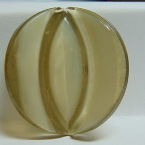 May include: A round, translucent, light brown and white glass bead with a ribbed design.