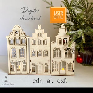 Puede incluir: Tres adornos de casa de madera cortados con láser, con intrincados detalles de ventanas y puertas. Las casas no están pintadas, con el texto "Digital download" y "Laser Cut File". El texto "cdr. ai. dxf." también es visible.