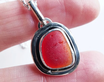 Red amberina sea glass & sterling silver pendant.