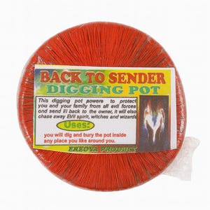 May include: A round, red digging pot with the text "BACK TO SENDER DIGGING POT" on a label. The label also includes instructions and an illustration. The pot is wrapped in clear plastic.