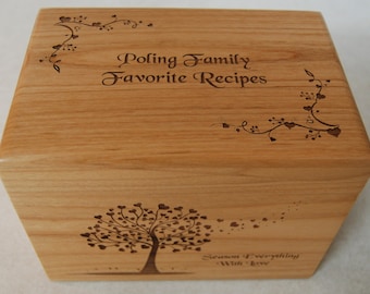 May include: A wooden recipe box with an engraved design of a tree with hearts and the text "Poling Family Favorite Recipes". The box also has a vine with hearts and the text "Season Everything With Love".