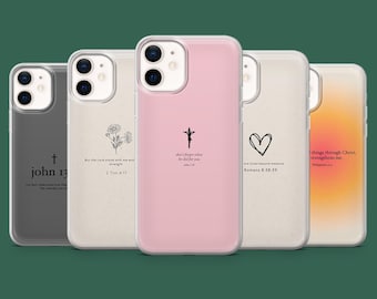 May include: A collection of five phone cases with various designs and quotes. The cases are in shades of gray, beige, and pink. Each case features a different design, including a cross, a heart, and floral elements, along with inspirational text. The cases are designed for a smartphone.