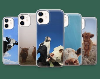 May include: A collection of five phone cases featuring images of cows. The cases display various cow breeds against blue sky and field backgrounds. The cases are clear with a protective bumper.