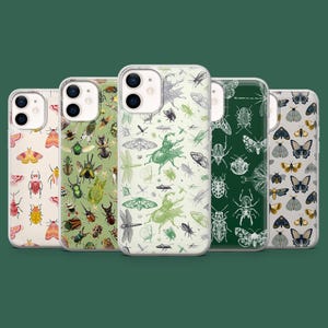 May include: A collection of five phone cases with insect illustrations. The cases feature various designs with beetles, butterflies, and other bugs in colors like green, cream, and white. The cases are made of clear plastic.