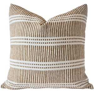 May include: Square throw pillow with a white background and a repeating pattern of vertical brown lines and dotted horizontal lines. The pillow has a soft, textured appearance and is likely made of fabric.