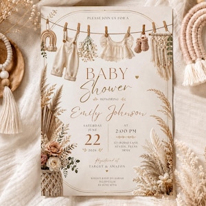 May include: A cream-colored baby shower invitation card featuring a clothesline with baby overalls, a lace top, booties, and macrame decor. The text reads: PLEASE JOIN US FOR A BABY Shower HONORING Emily Johnson SATURDAY JUNE 22 2026 AT 2:00 PM.
