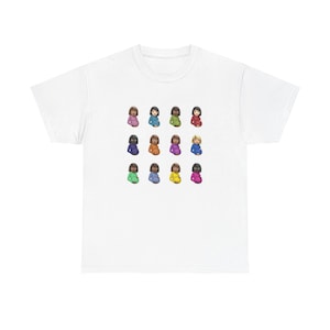 May include: White t-shirt featuring a colorful graphic of 16 stylized figures in various colors. The figures are arranged in four rows of four, each with a unique hair and clothing color. The design is centered on the front of the shirt.