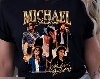 May include: Black t-shirt featuring a collage of images of Michael Jackson with the text "MICHAEL Jackson" in gold lettering. The shirt showcases various iconic poses of the artist, capturing his dynamic stage presence.