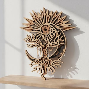 May include: A layered wooden wall art piece featuring a tree, sun, and moon design. The artwork is made of light and dark brown wood, with intricate cut-out details. The sun has pointed rays, and the moon cradles the tree.
