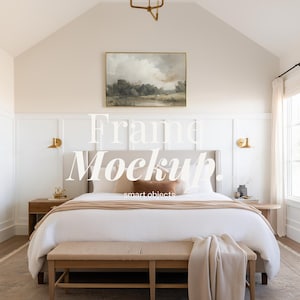 May include: A bedroom interior with a large bed, bench, and artwork. The bed has white linens, a tan throw, and a brown pillow. A woven bench sits at the foot of the bed. The artwork is a landscape painting in a gold frame.