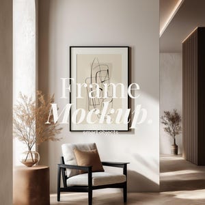 May include: Interior scene featuring a framed art print, a black armchair with a cream cushion and a brown pillow. A small side table with a glass vase and dried plants is on the left. The text "Frame Mockup. smart objects" is on the art print.