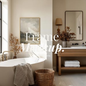 May include: A bathroom scene with a white oval bathtub, a woven basket, and a framed landscape painting. A towel hangs on the tub's edge. The room features a wooden vanity with a mirror and a window with natural light.