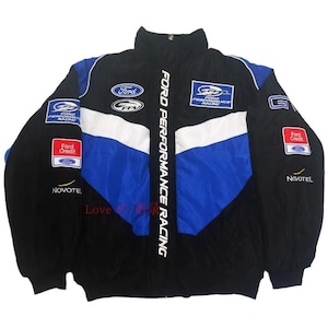 May include: A black, blue, and white Ford Performance Racing jacket. The jacket displays the Ford logo, sponsor logos, and the words "FORD PERFORMANCE RACING" vertically. It has a high collar and a full zip.