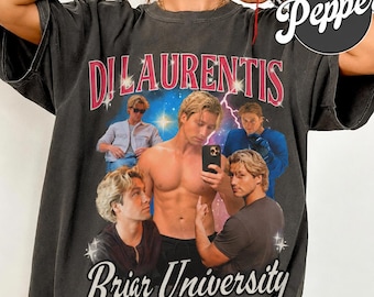 May include: Dark gray t-shirt featuring a collage of images with a man and the text "Di Laurentis" and "Briar University" in a retro style. The shirt has a vintage, worn look.