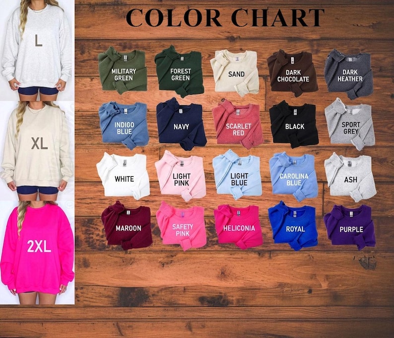 May include: A color chart displays various sweatshirt colors, including Military Green, Navy, and Scarlet Red. The chart also shows the sizes L, XL, and 2XL. The sweatshirts are displayed on a wooden background.