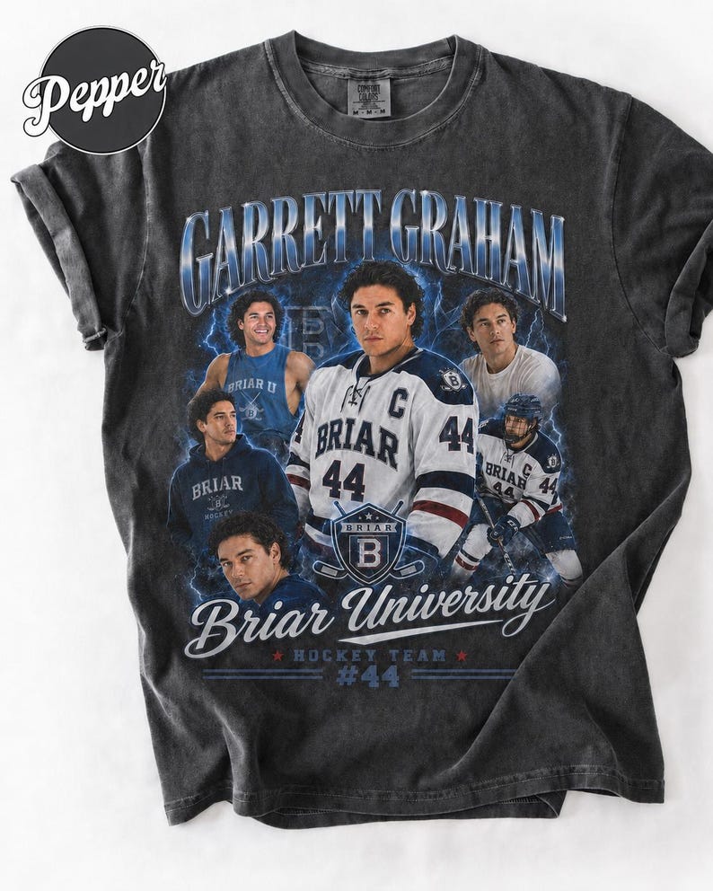 May include: Dark gray t-shirt featuring a graphic of Garrett Graham, a hockey player, with the text "Briar University Hockey Team #44." The design includes multiple images of the player and the Briar University logo.