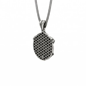 May include: A silver pendant necklace with a honeycomb design. The pendant is oval-shaped with a detailed honeycomb pattern in the center. The necklace has a delicate chain and a simple bail. The pendant is made of a shiny, silver-colored metal.