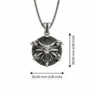May include: Silver pendant necklace featuring a detailed, circular pendant with a central bull-like figure and three animal heads. The pendant measures 1.18 inches (30.00 mm) in diameter and is suspended from a chain.