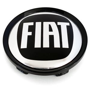 May include: A black and silver Fiat car emblem. The emblem is round with a black outer ring and a silver inner oval. The word "FIAT" is in bold white letters in the center of the emblem.