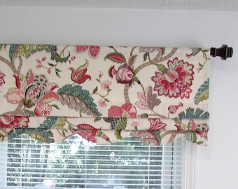 May include: A window valance featuring a cream-colored fabric with a multi-colored floral and botanical print in shades of red, pink, green, and teal. The valance has a scalloped bottom edge and is hung on a dark brown curtain rod.