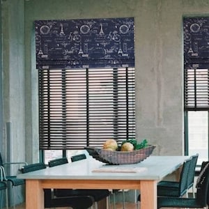 May include: A dining room with a wooden table and chairs. The windows have black roman shades with a Parisian-themed design. The shades feature a white graphic of bicycles, the Eiffel Tower, and the word "Paris".