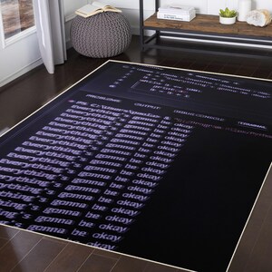 May include: A large rectangular black rug featuring white text repeating "Everything's gonna be okay". The rug has a computer code theme, with lines of code and a debug console design.