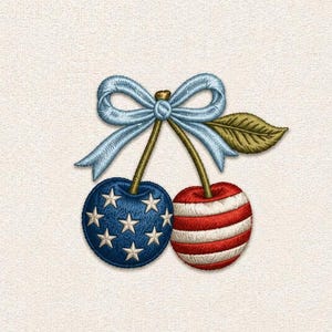 May include: Embroidered cherry design featuring a blue cherry with white stars and a red and white striped cherry. A light blue bow and green leaf sit above the cherries. The design is on a cream-colored background.