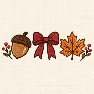 May include: An embroidery design featuring a brown acorn with a textured cap, a central dark red bow, and an orange maple leaf. Small sprigs with red berries and green leaves are positioned on the outer sides of the acorn and the maple leaf.
