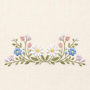 May include: An embroidery design on off-white fabric featuring a symmetrical arrangement of wildflowers. The pattern includes two large white daisies with yellow centers, surrounded by smaller blue, pink, and light purple blossoms with green leaves.