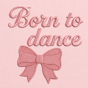 May include: A light pink fabric surface featuring the embroidered text Born to dance in a darker pink cursive script. Below the text is a large, detailed embroidered bow in the same matching dark pink thread, creating a cohesive design.