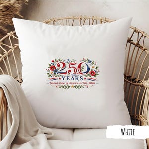 May include: White square pillow with a patriotic design celebrating 250 years of the United States of America. The design includes the text "250 YEARS" with red, white, and blue floral accents and the years 1776-2026.