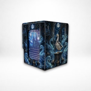 May include: A rectangular deck box for trading cards featuring a dark blue nocturnal scene with a central white goose standing on a stone pedestal, surrounded by ghostly swan figures, stone pillars, and a full moon, with a card slot displaying text.