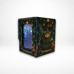 May include: A rectangular deck box featuring a dark forest illustration with a red panda wizard holding a staff. The front panel has a clear window displaying a blue-toned trading card with text, set against a backdrop of glowing lanterns.