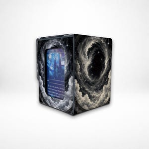 May include: A rectangular deck box featuring a black and white swirling nebula design with stars. A central window displays a blue stained-glass style card with text that reads, Pay 1 life, Sacrifice Flooded Strand; Search your library for a Plains or Island card, put it into the battlefield, then shuffle.