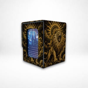 May include: A rectangular deck box featuring a gold and black illustration of a roaring lion surrounded by sunburst rays and clouds. The front panel has a clear window displaying a blue and purple trading card with visible text.