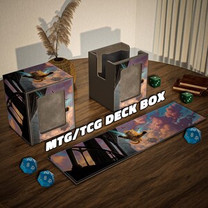 May include: A set of MTG/TCG deck boxes and playmat. The boxes are square with a fantasy art design and a window. The playmat features the same art. Dice and a small book are also on the wooden surface.