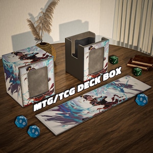 May include: A set of MTG/TCG deck boxes and accessories. The boxes feature a fantasy art design with blue and red accents. Includes a deck box, a card holder, and a playmat, along with dice.