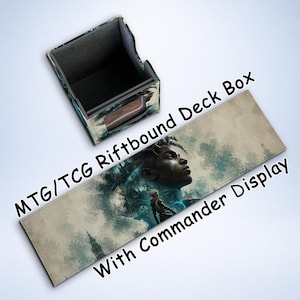May include: A deck box and playmat set for MTG/TCG Riftbound, featuring a portrait of a person with blue and teal accents. The box is open, and the playmat has the text "With Commander Display".