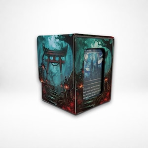 May include: A rectangular deck box featuring a dark fantasy illustration of a red torii gate in a misty forest with glowing lanterns. The front panel has a clear window displaying a trading card with stained glass artwork and printed text.