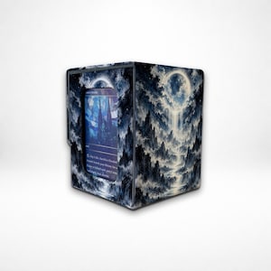 May include: A rectangular card storage box featuring a dark blue and white illustration of a moonlit mountain landscape with a waterfall. A rectangular cutout on the front displays a trading card with blue stained glass artwork.