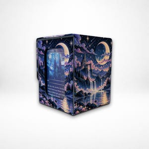 May include: A rectangular deck box featuring a dark purple and blue night sky illustration with a crescent moon, shooting stars, a castle on a cliff, and a waterfall. A rectangular window on the front displays a card with text and stained glass art.