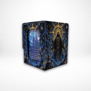 May include: A rectangular card storage box featuring a dark blue and gold illustration of a hooded figure with a glowing halo, surrounded by skulls and cosmic patterns. A clear window on the front displays a single trading card with blue stained glass art.
