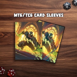 May include: Two card sleeves with a comic book illustration of Venom. The sleeves have a black background with a yellow and green colour scheme. The text "MTG/TCG CARD SLEEVES" is printed at the top. Dice are visible in the background.