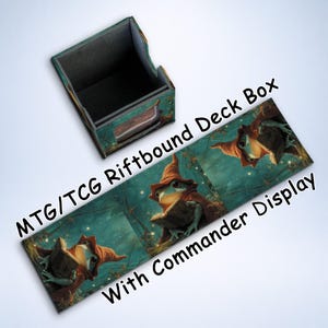 May include: A deck box and playmat set for MTG/TCG games. The box is teal and black, and the playmat features a frog wizard reading a book. Text on the playmat reads "MTG/TCG Riftbound Deck Box With Commander Display."