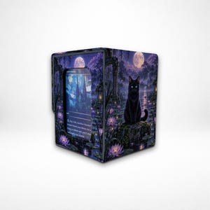 May include: A rectangular deck box featuring a fantasy illustration of a black cat sitting on a rock in a pond with purple lotus flowers, a full moon, and stone arches. A trading card is visible in the front window, displaying blue stained glass art.